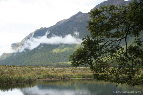 Clouds over mountain near lake